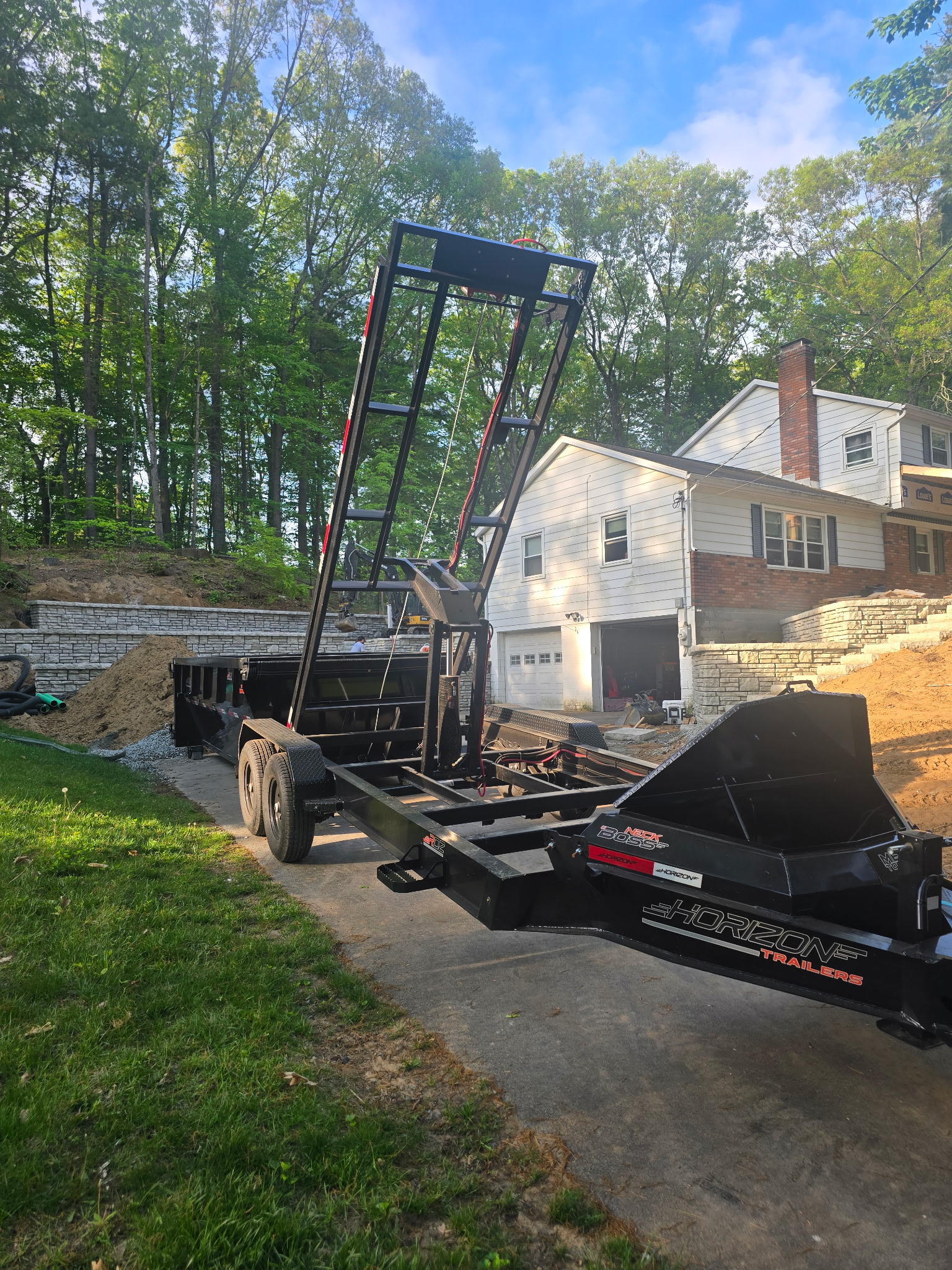 Toss Boss dumpster trailer placed in a driveway
